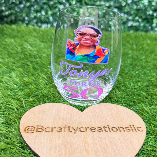 Custom 15 oz stemless wine glass featuring a personalized photo sticker of a smiling person.